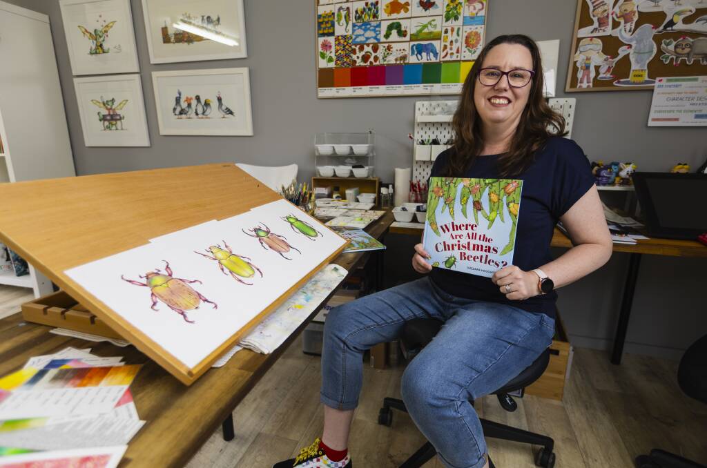 Suzanne Houghton poses with her new picture book called 'Where Are All the Christmas Beetles?'. Picture by Ash Smith