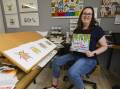 Suzanne Houghton poses with her new picture book called 'Where Are All the Christmas Beetles?'. Picture by Ash Smith